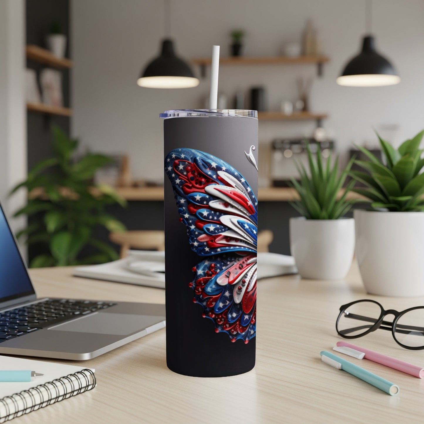 Black tumbler with a patriotic butterfly design and white straw.