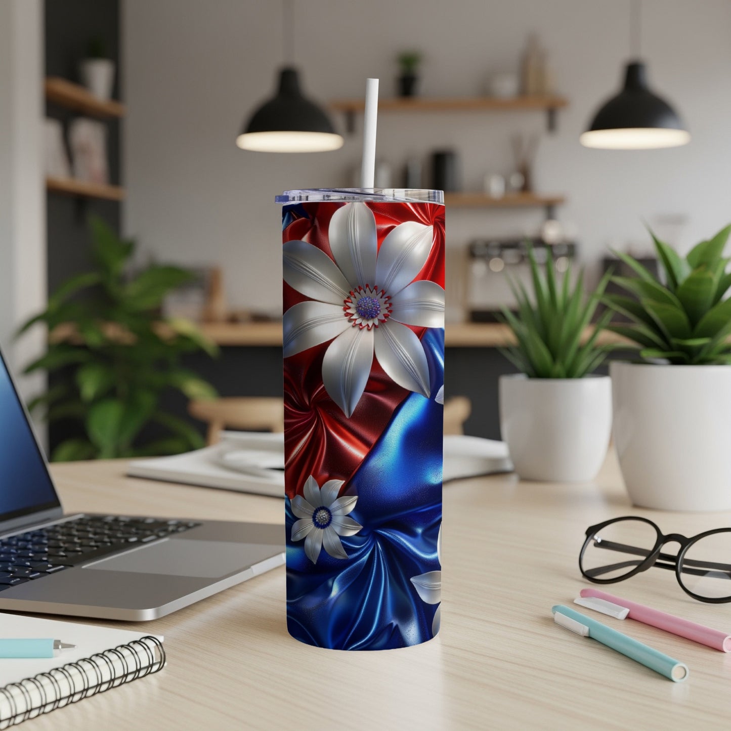 Red and blue satin tumbler with white floral design and straw.