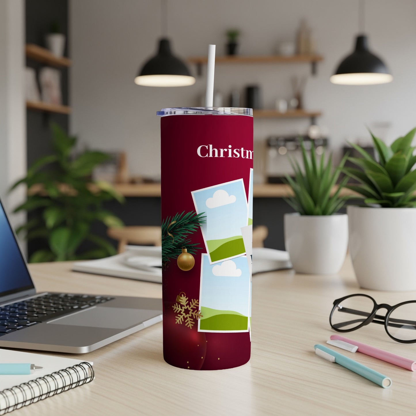 Maroon tumbler with "Christmas" text and overlaid photos, adorned with a pine sprig and ornament.