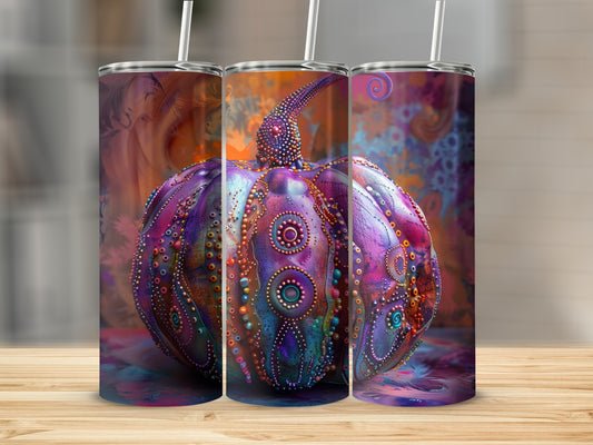 Purple decorative pumpkin tumbler with straws on a wooden surface.