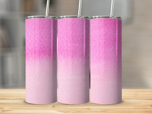 Three pink ombre tumblers with straws on a wooden surface.