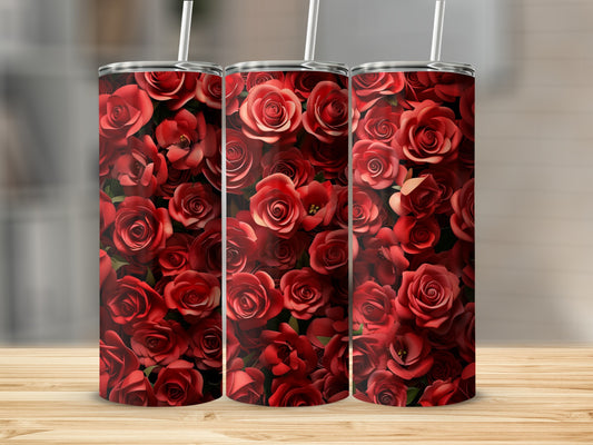 Three red rose tumblers with straws on a wooden surface.
