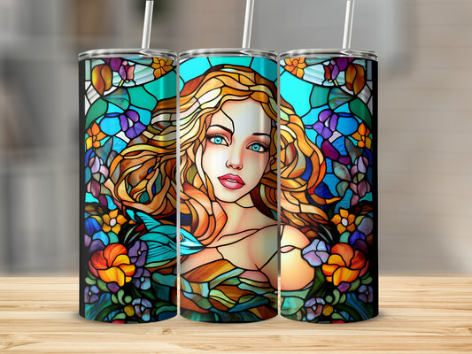 Stained glass art of a woman with blonde hair and blue eyes surrounded by flowers.