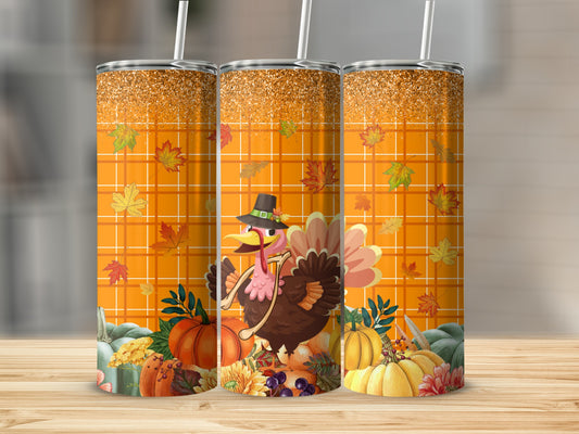 Three Thanksgiving tumblers with plaid, leaves, pumpkins, and a turkey.