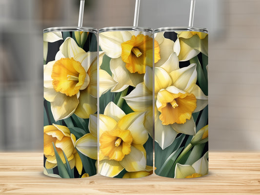 Three tumblers with yellow and white daffodils and green leaves.