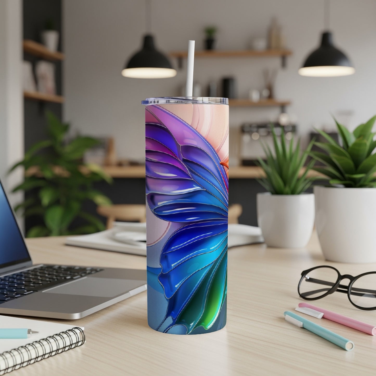 Butterfly wing design on a tall, insulated tumbler with a straw.