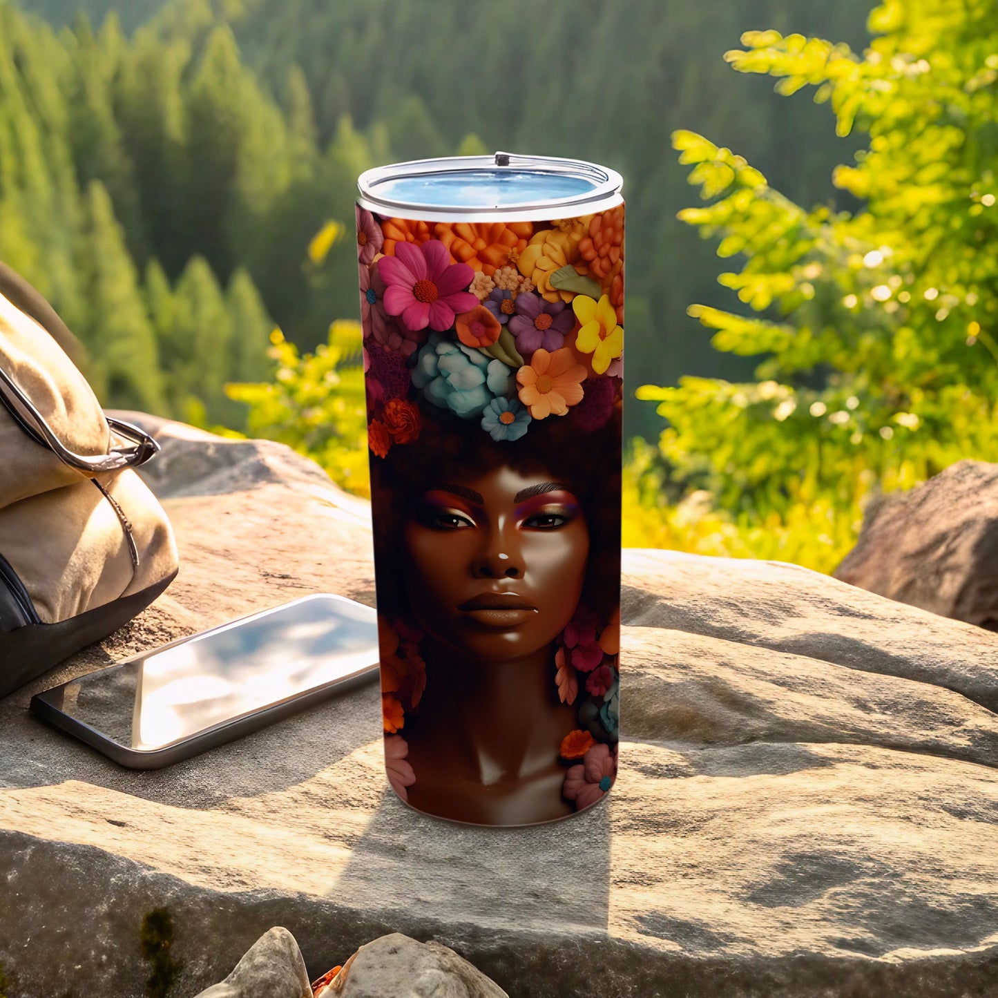 Tumbler with floral portrait of a woman, phone, and backpack in nature.