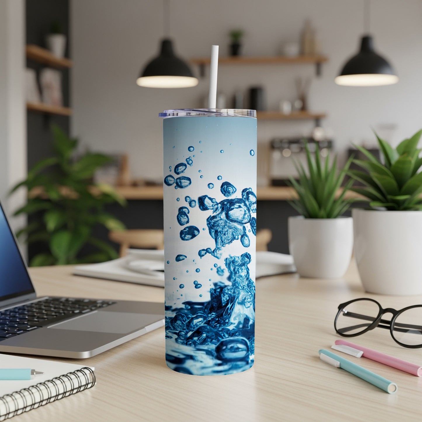 Blue and white abstract water splash design on a white tumbler.