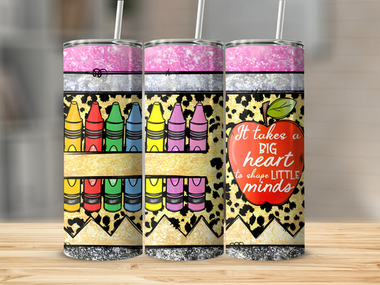 Three colorful tumblers with crayons and an apple design reading "It takes a big heart to shape little minds."