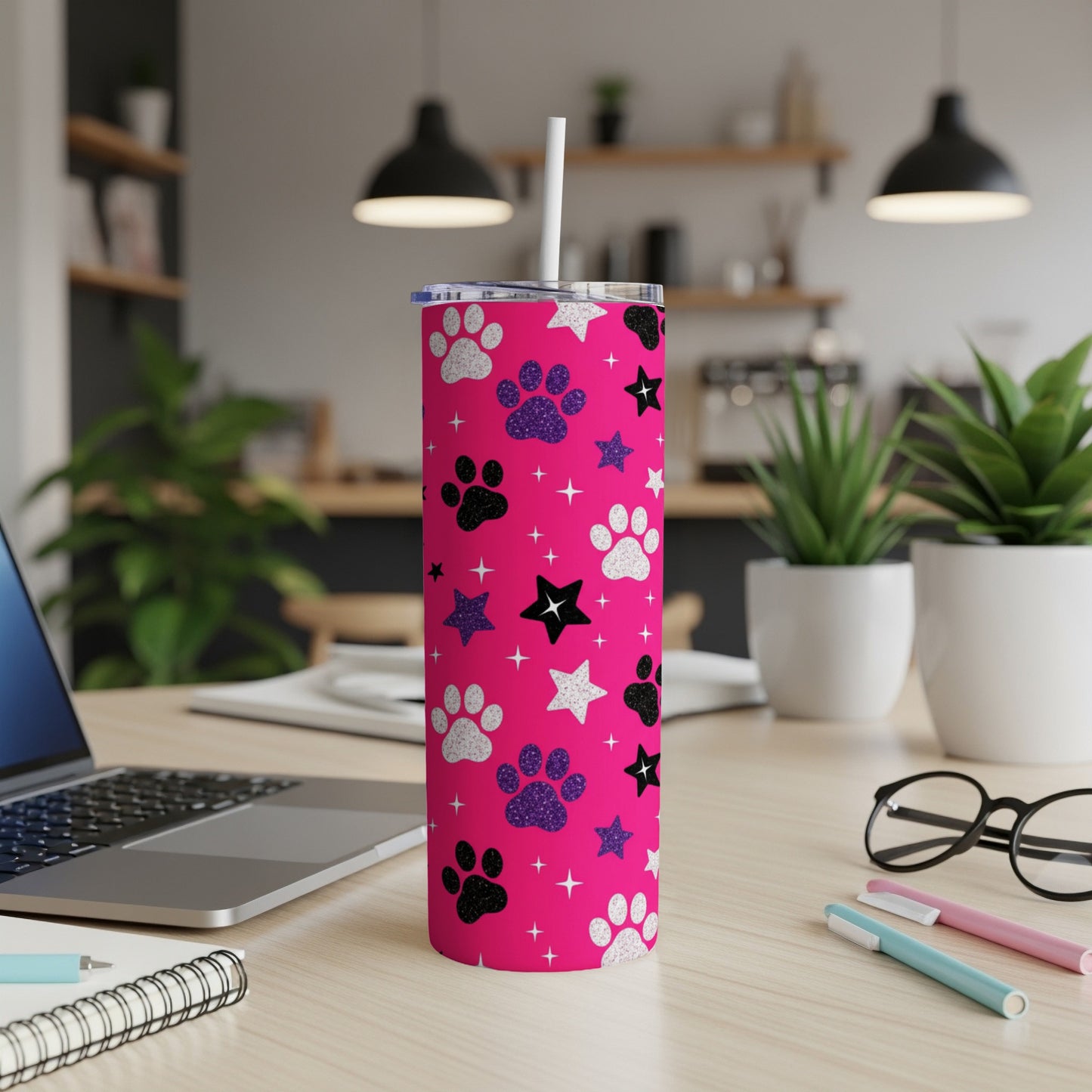 Pink tumbler with paw prints and stars, includes straw.