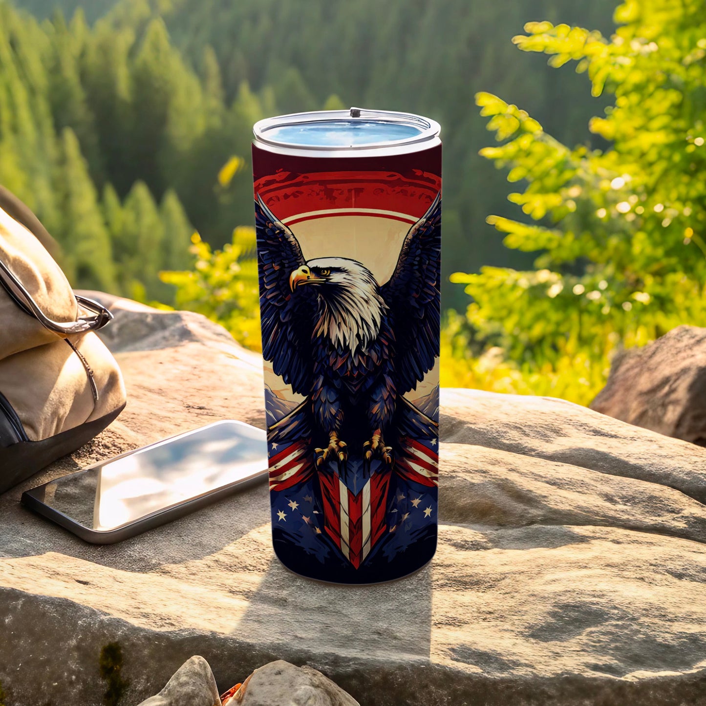 Patriotic tumbler with eagle and American flag design on rocky surface.