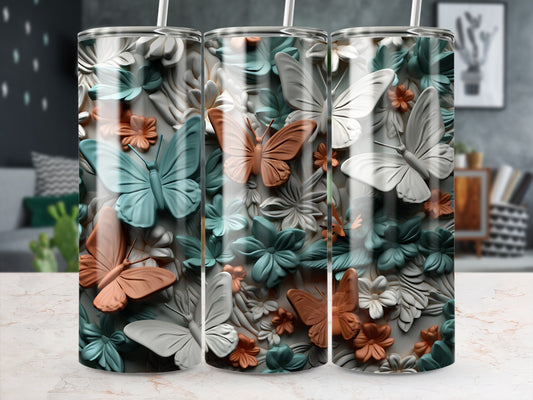 Three tumblers with embossed butterflies and floral patterns in muted colors.
