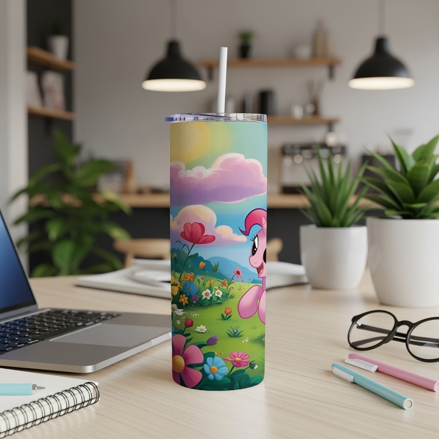 Pink pony with flowers on a colorful, landscape-themed tumbler with straw.