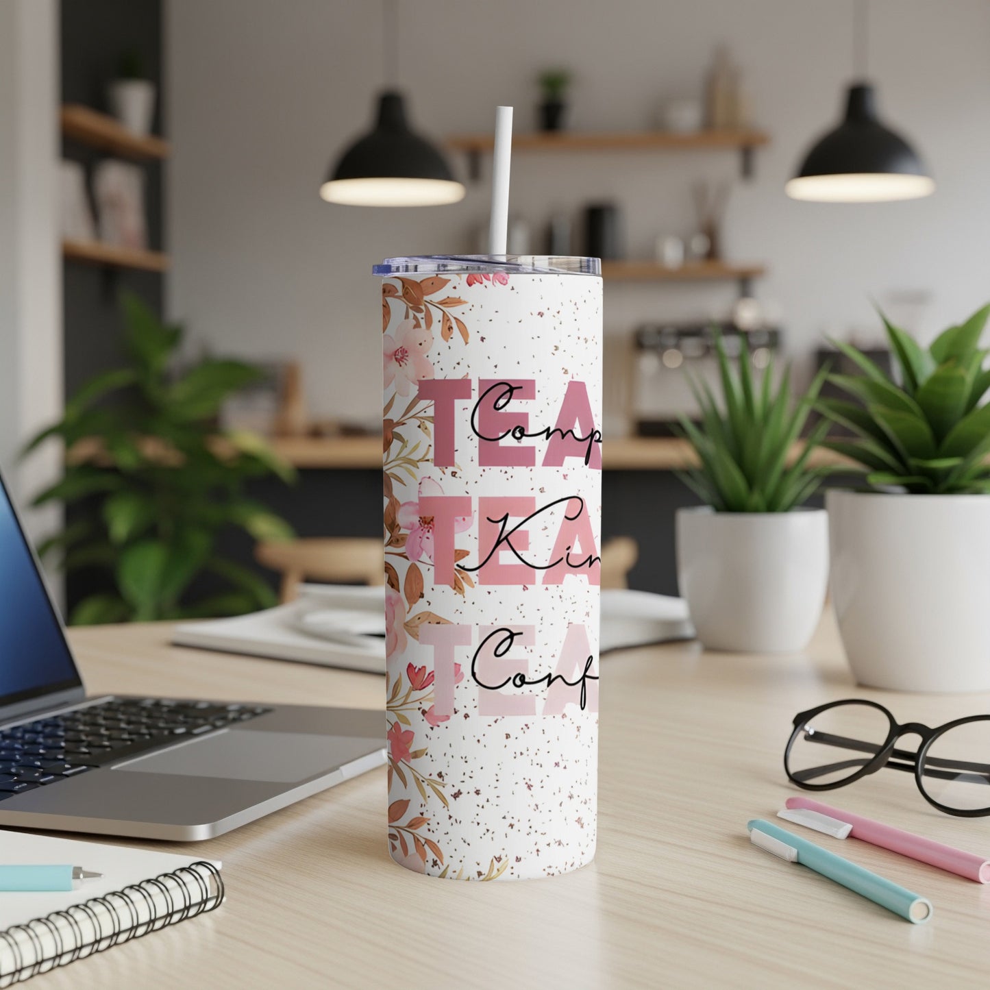 White tumbler with floral design and text "Comp," "Kin," "Conf."