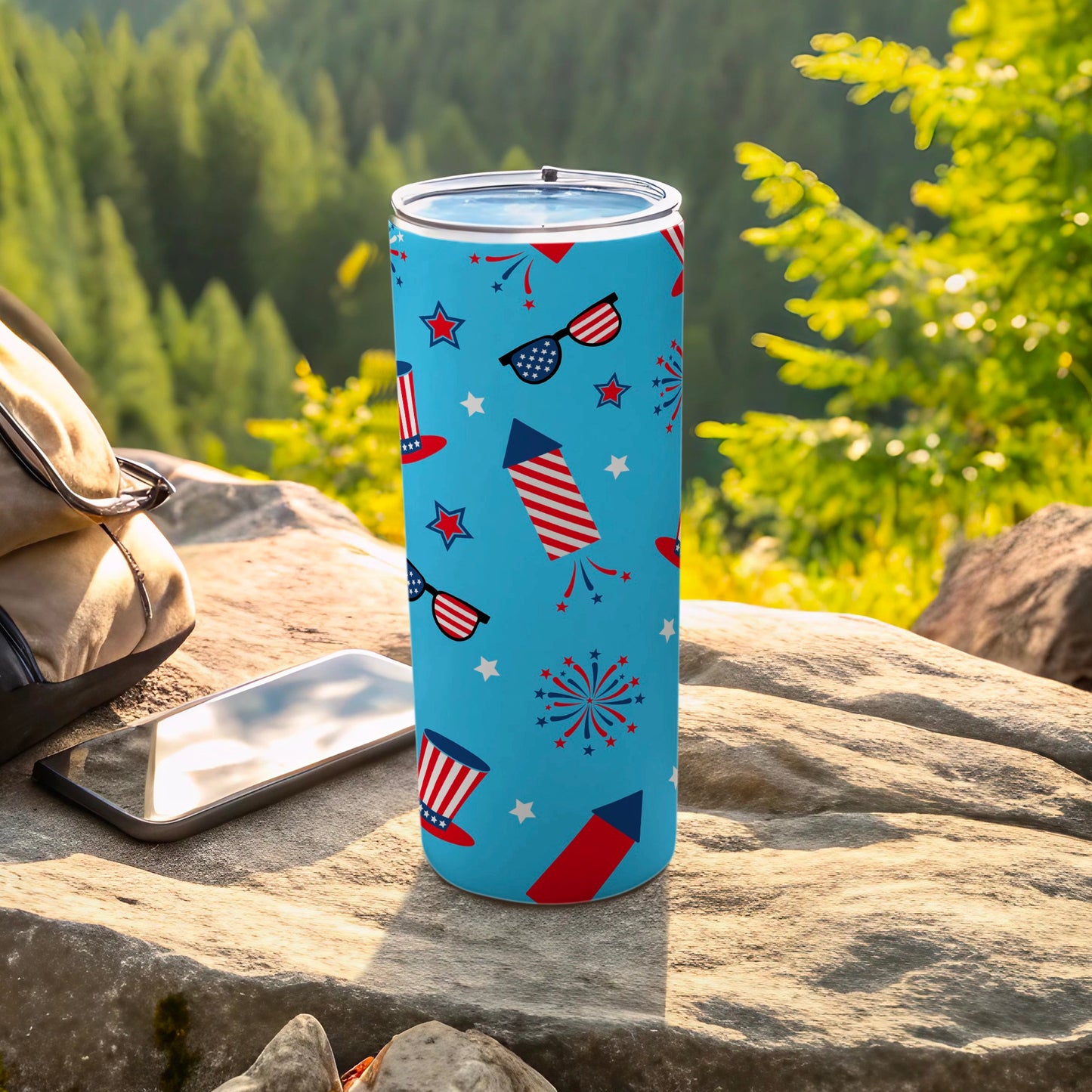 Blue tumbler with red, white, and blue fireworks, stars, and sunglasses pattern.
