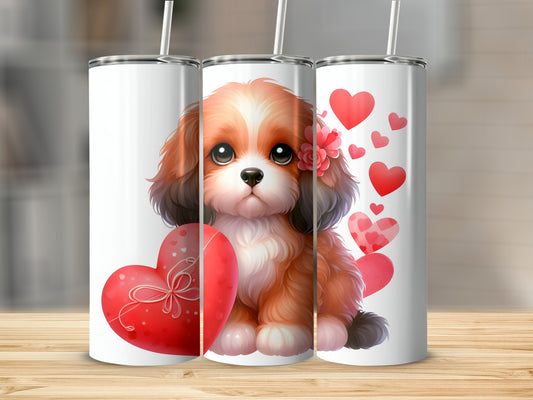 Fluffy puppy with heart, sitting in front of Valentine's Day themed tumblers.