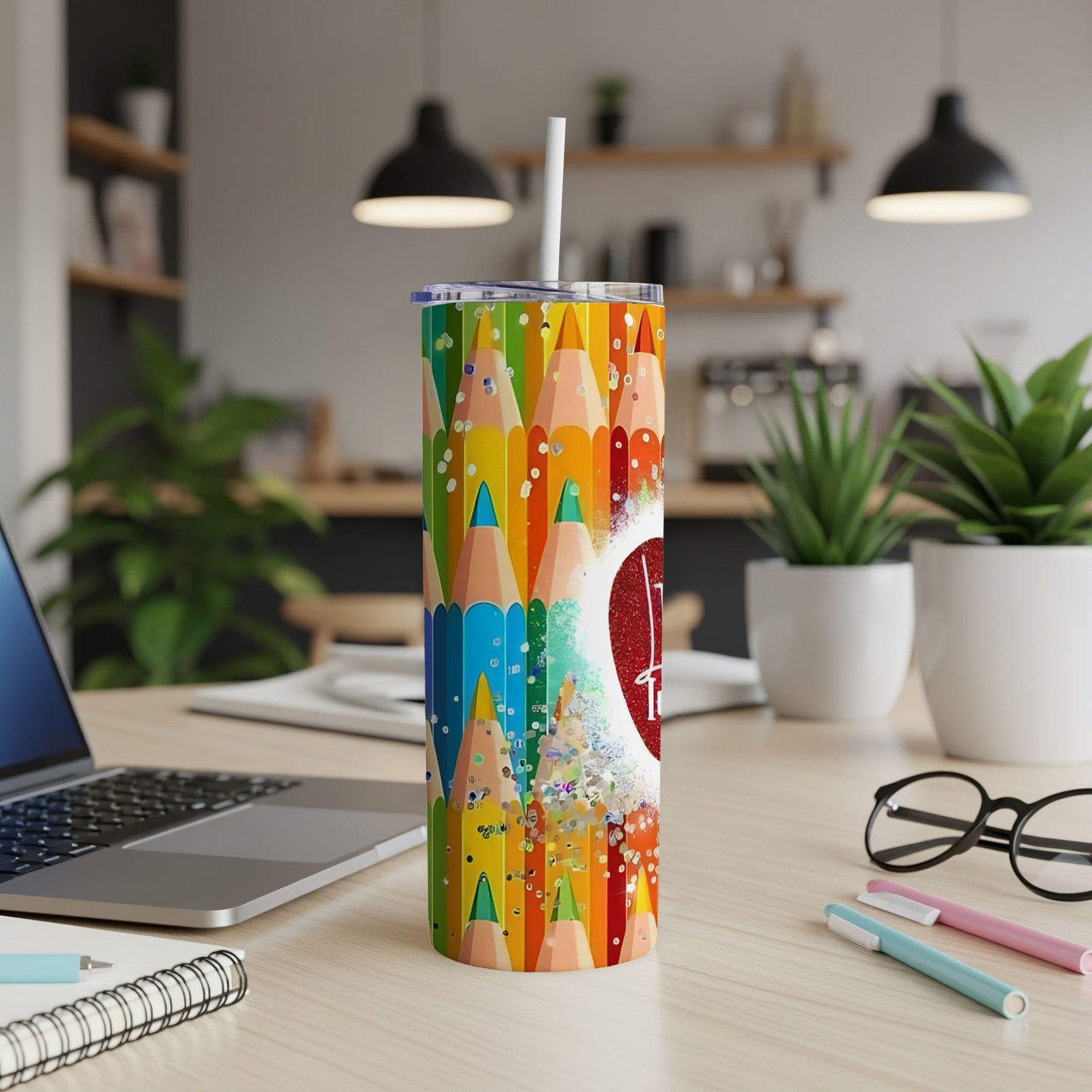 Colorful pencils and glitter pattern on a tumbler with a white straw.