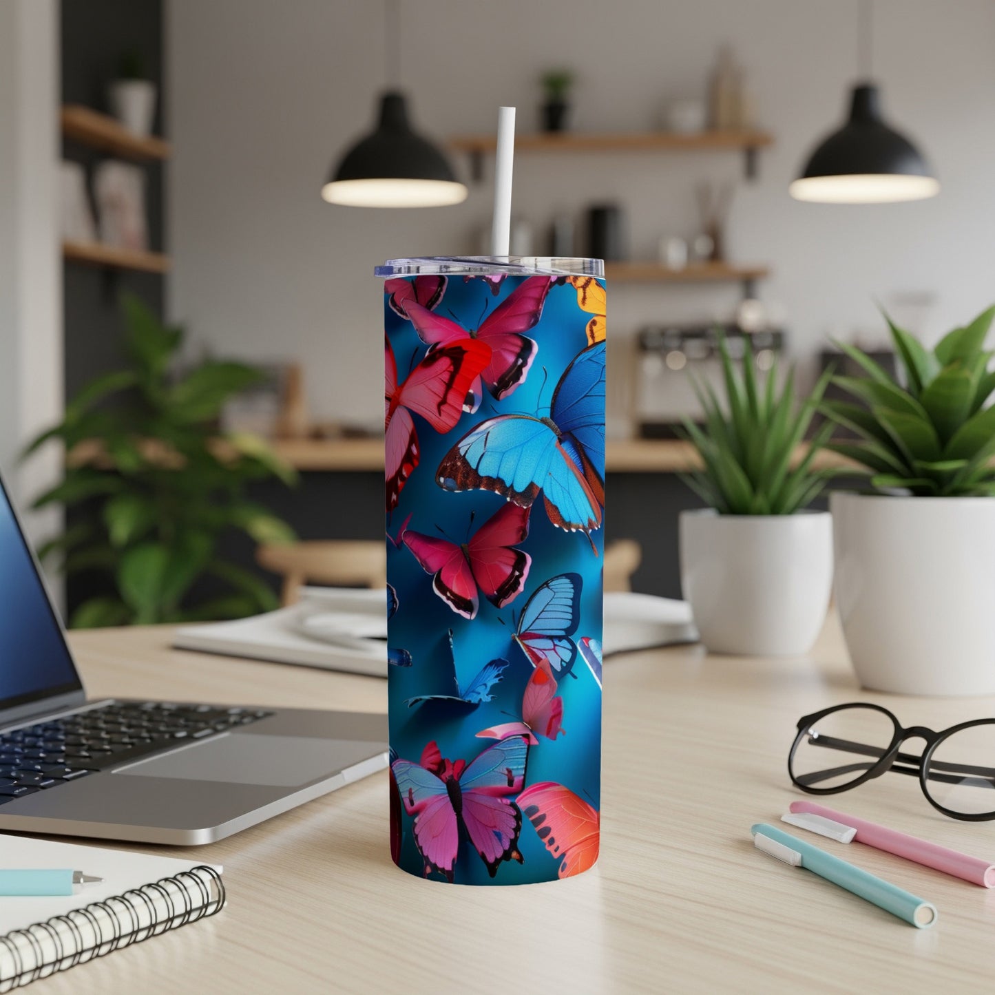 Tumbler with a vibrant blue background and scattered colorful butterflies.