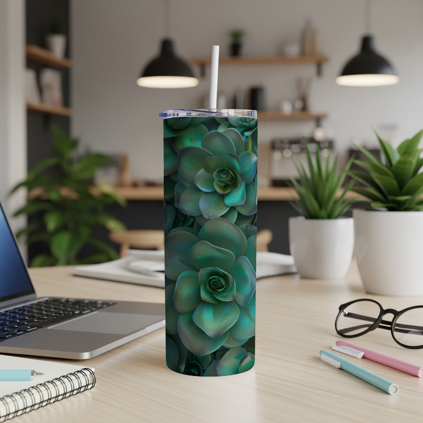 Green succulent pattern on a white insulated tumbler with a straw.