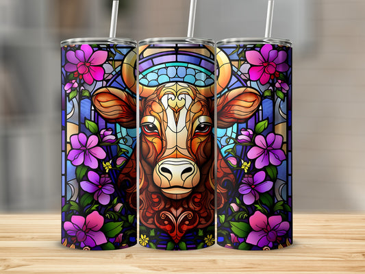 Stained glass cow with purple flowers on a tumbler.
