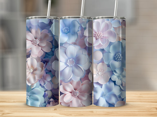 Three floral tumblers with pastel pink and blue flowers on a wooden surface.