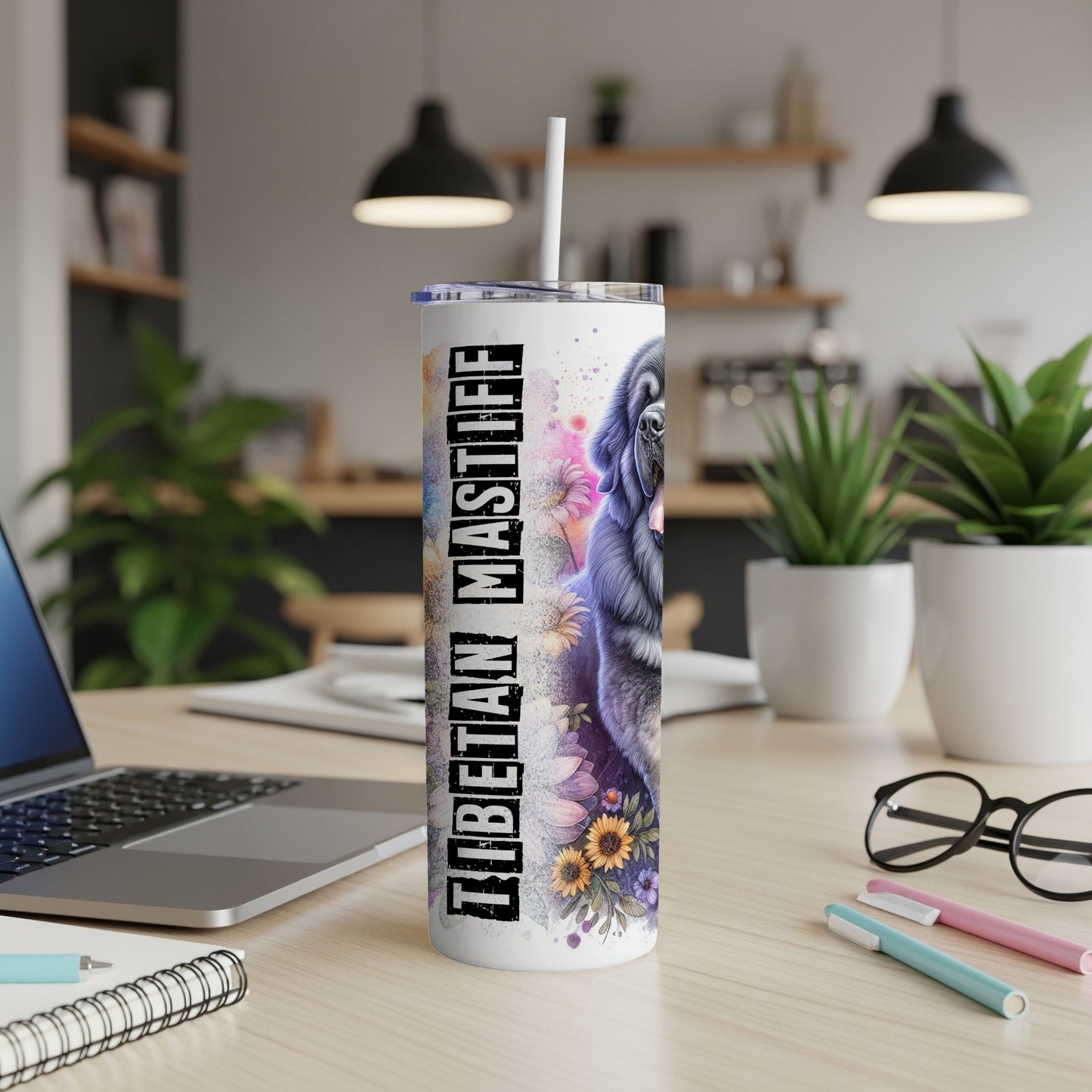 Tibetan Mastiff graphic on a white tumbler with a straw, on a desk.