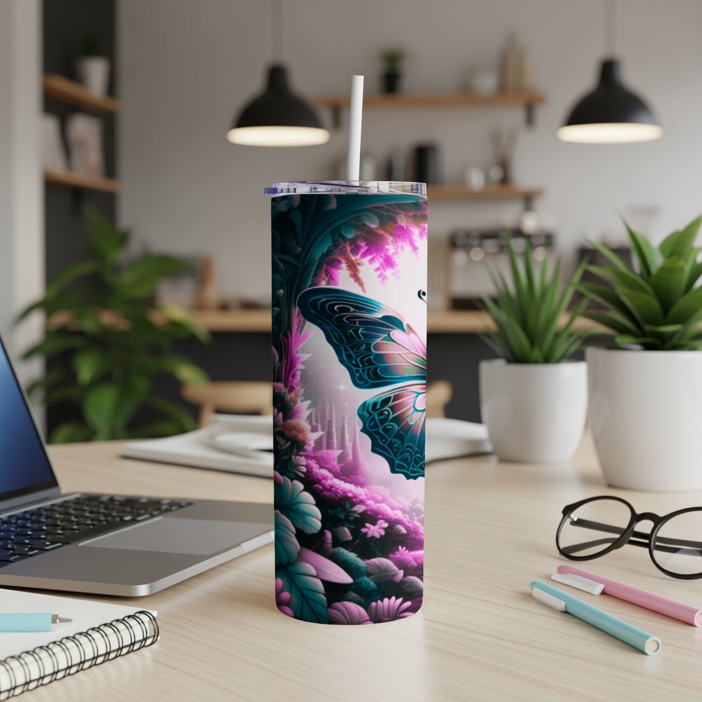 Butterfly and floral design on a skinny tumbler with a straw.