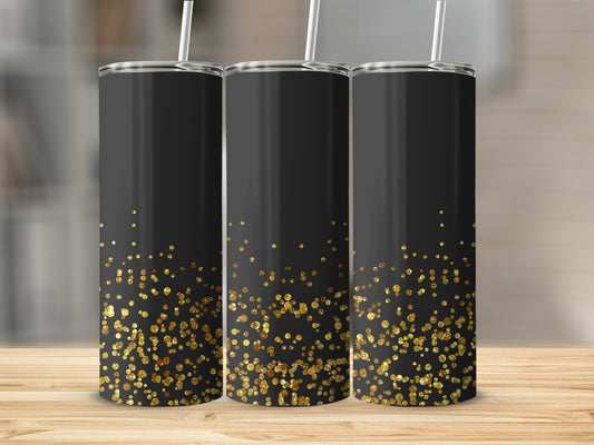 Three black tumblers with scattered gold glitter accents stand on a wooden surface.