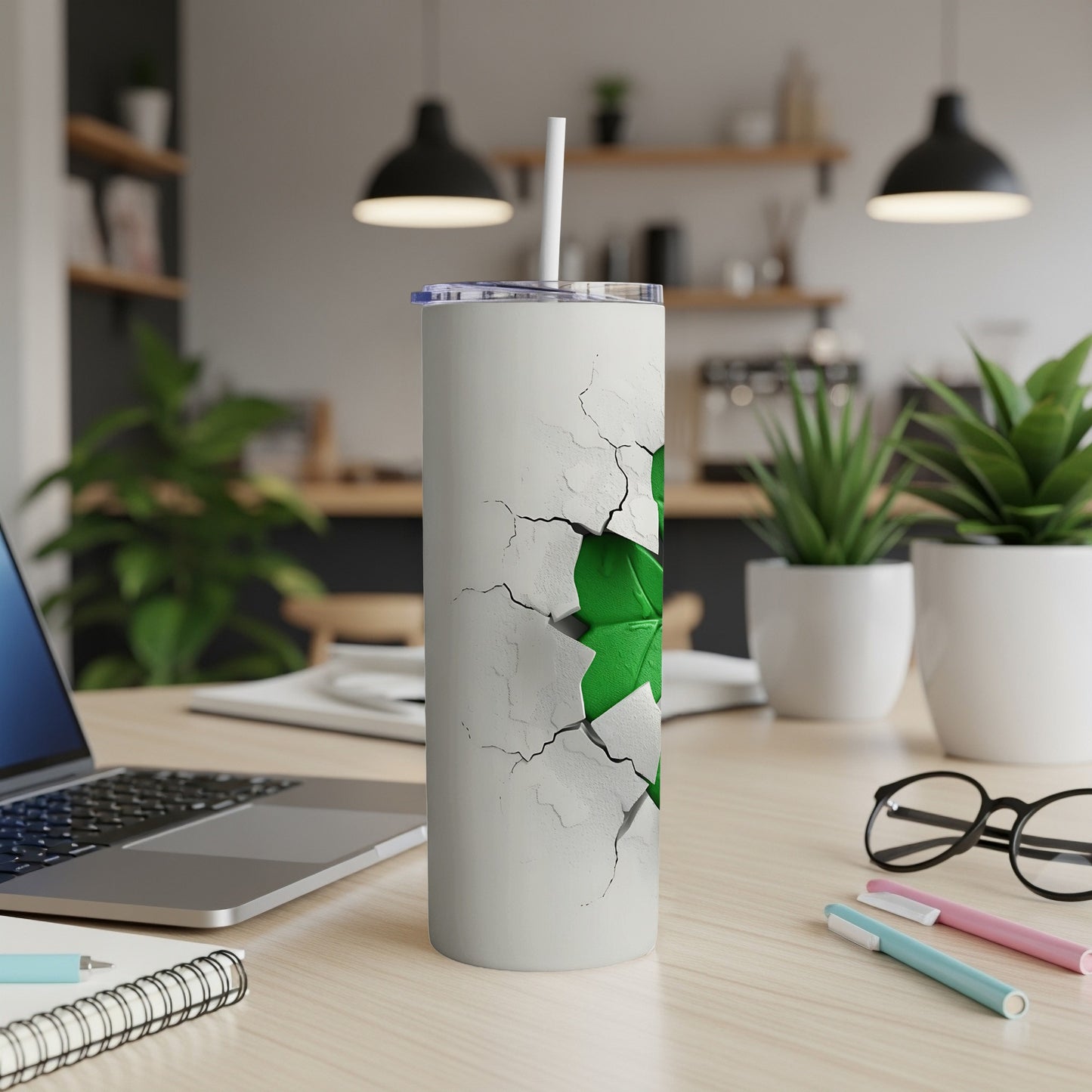 White tumbler with green shamrock design, cracked concrete texture.