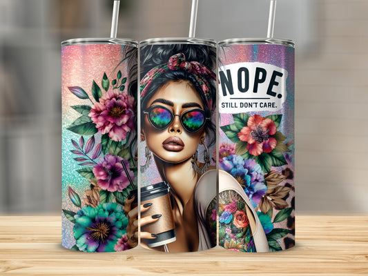 Three tumblers: one with flowers, one with a woman and coffee, one with "Nope. Still Don't Care."