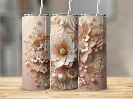 Three floral-embellished tumblers with pearls on a wooden surface.