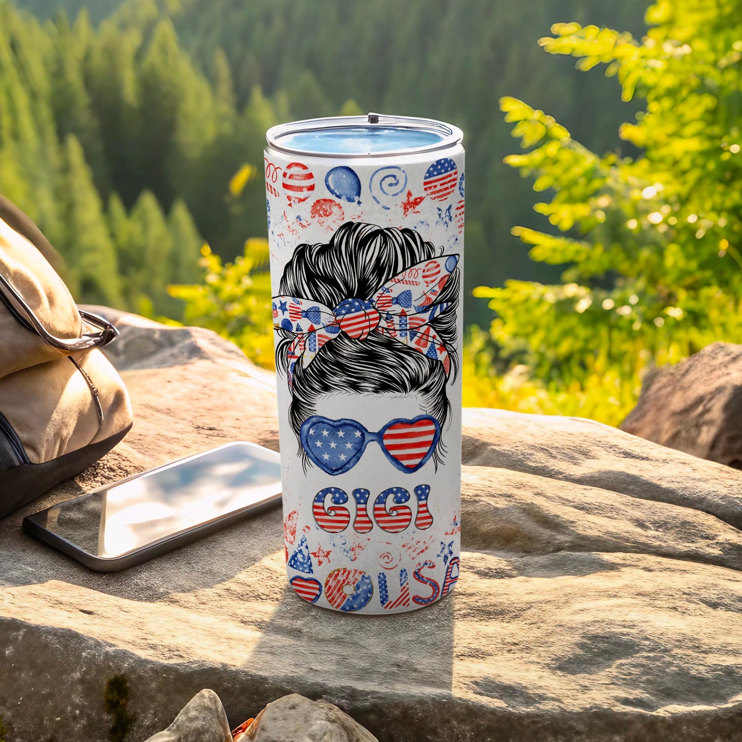 "Merica" tumbler with messy bun and sunglasses, on a rock outdoors.