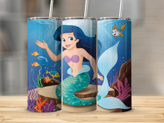 Ariel the mermaid swims in the ocean with Flounder and coral.