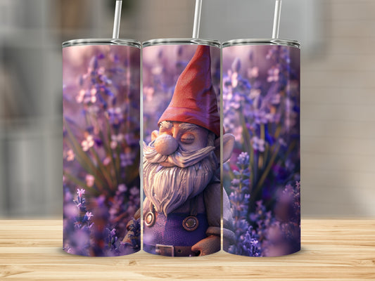 Gnome with red hat and blue overalls sits among purple flowers.