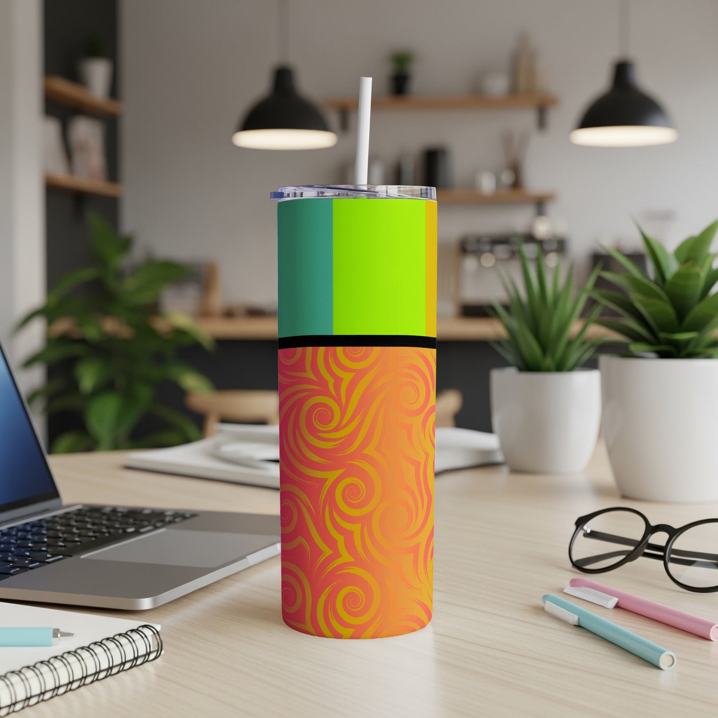 Tumbler with vertical color blocks and orange and yellow swirl pattern.