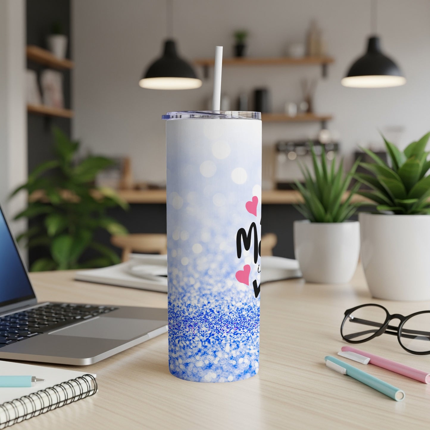 White tumbler with blue glitter and pink hearts, text reads "Mom".