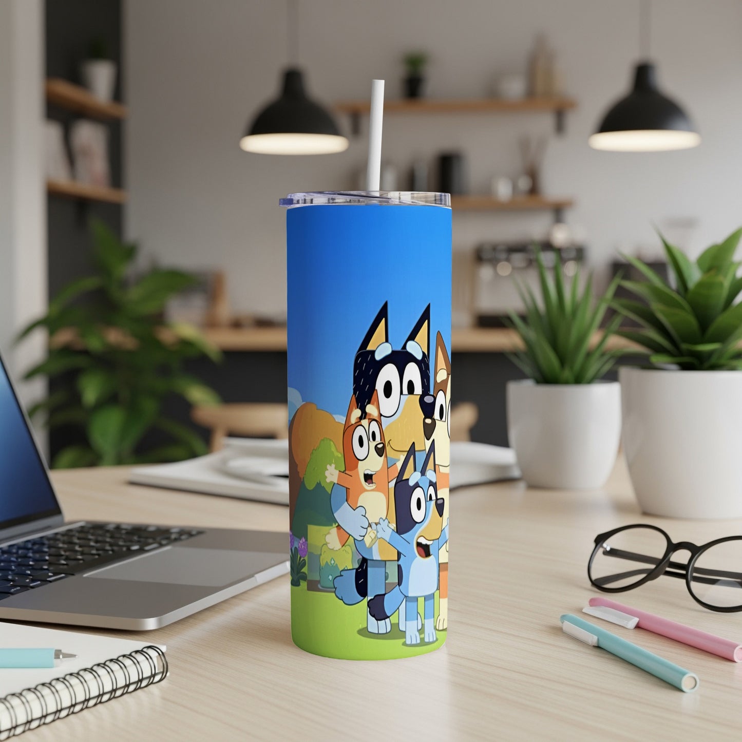 Bluey and Bingo characters on a blue and green cartoon tumbler.