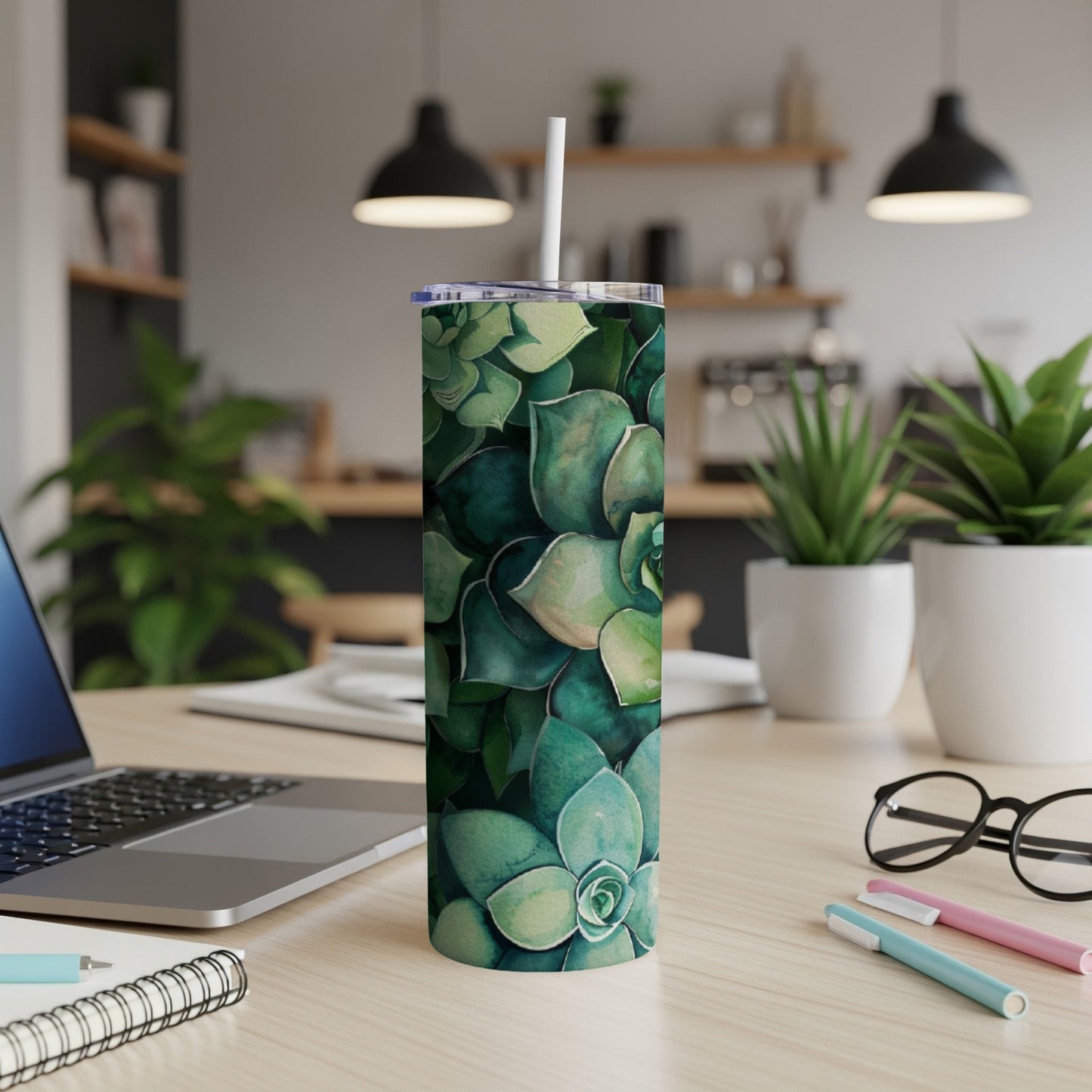 Green succulent pattern on a tall tumbler with a straw.