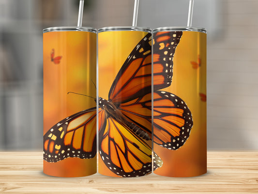 Monarch butterfly design on a stainless steel tumbler.