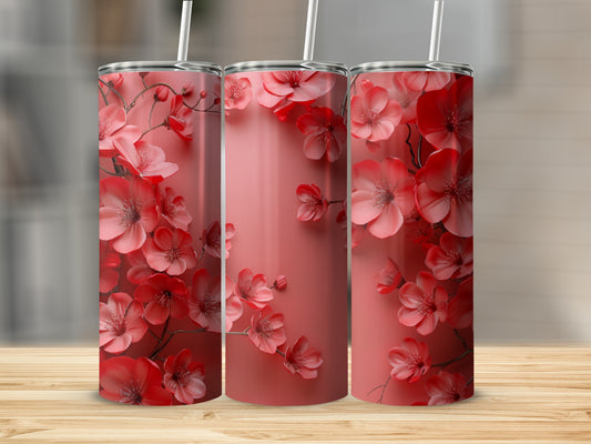 Three tumblers with a repeating coral floral pattern on a light coral background.