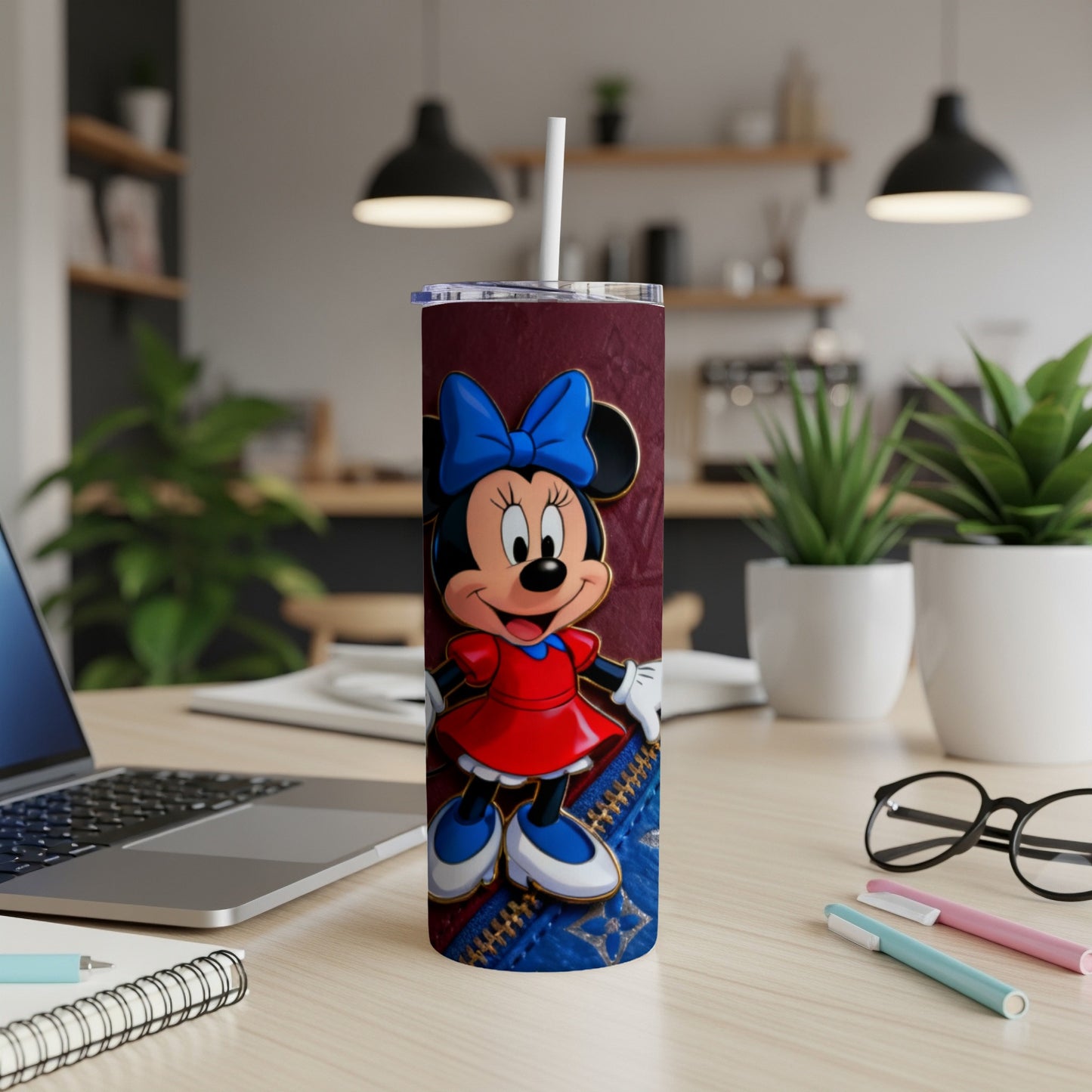 Minnie Mouse on a maroon tumbler with blue accents and a straw.