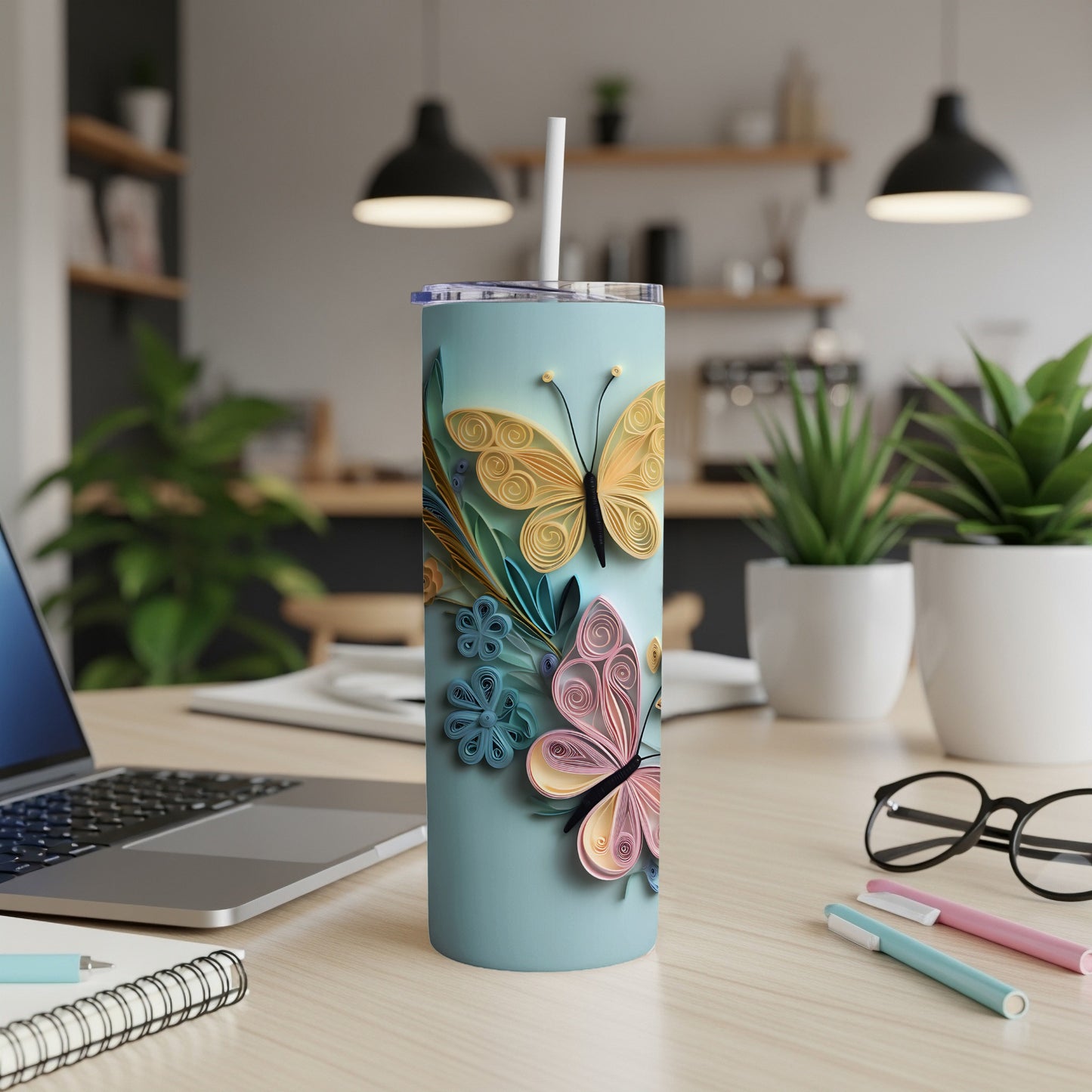 Light blue tumbler with quilled butterflies and flowers, a straw.