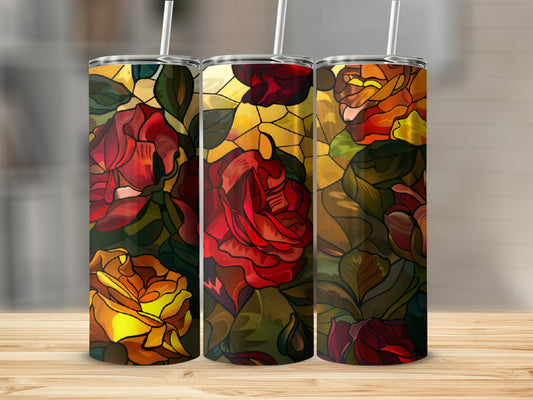Three tumblers with stained glass rose designs on a wooden surface.
