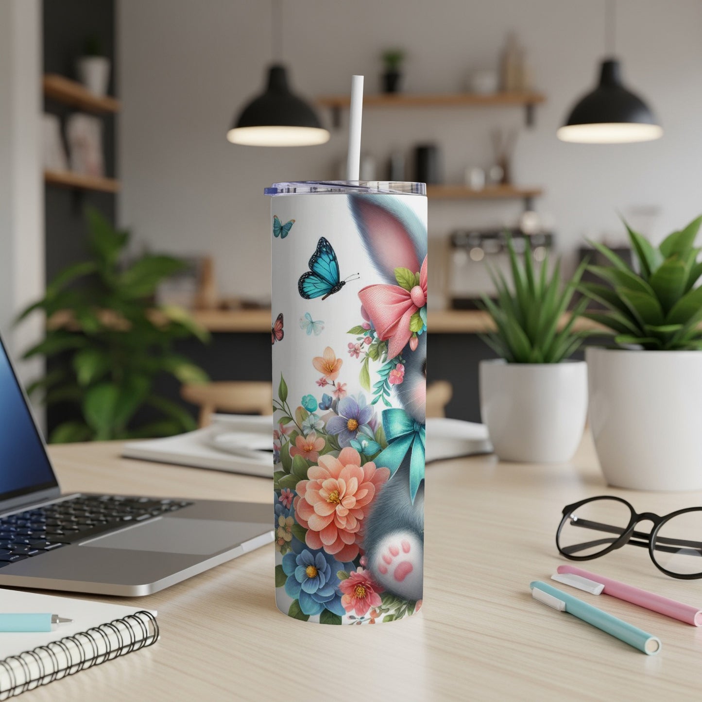 Tumbler with a floral design featuring a bunny and butterflies.