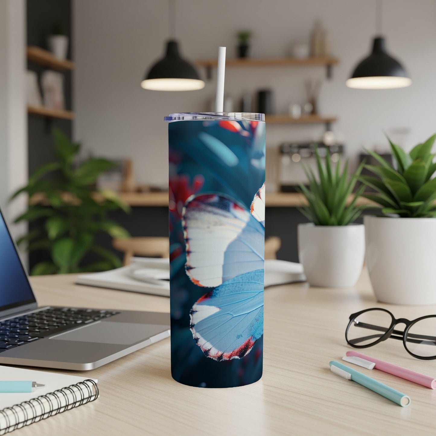 Blue and white butterfly on a blue and red floral pattern tumbler.