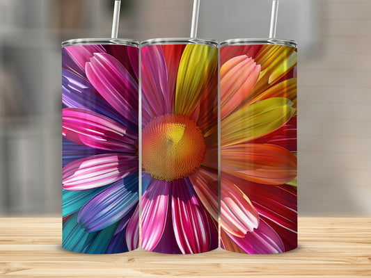 Three tumblers with vibrant floral petal designs in rainbow colors on a wooden surface.