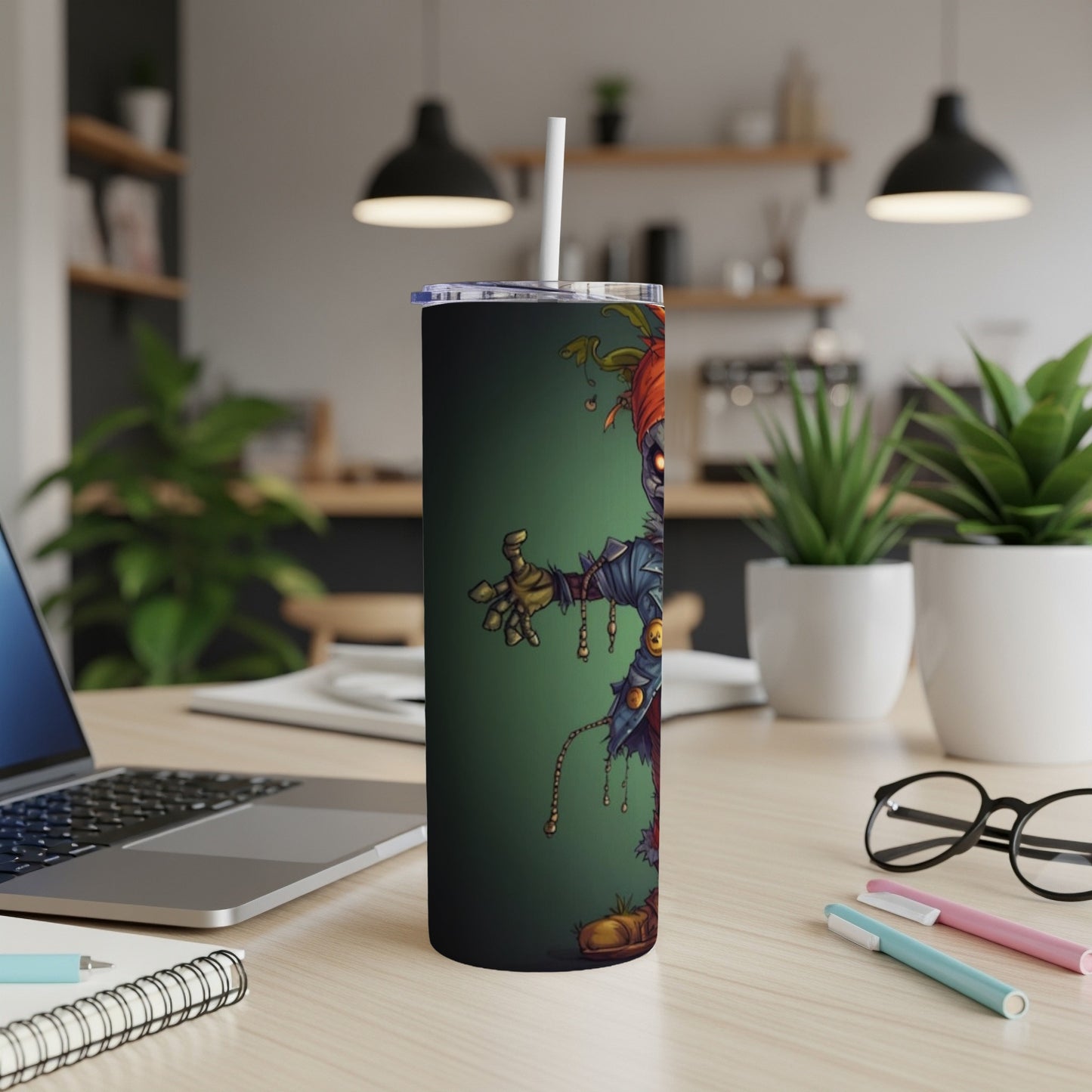 Tall tumbler with a cartoon scarecrow design and a white straw.