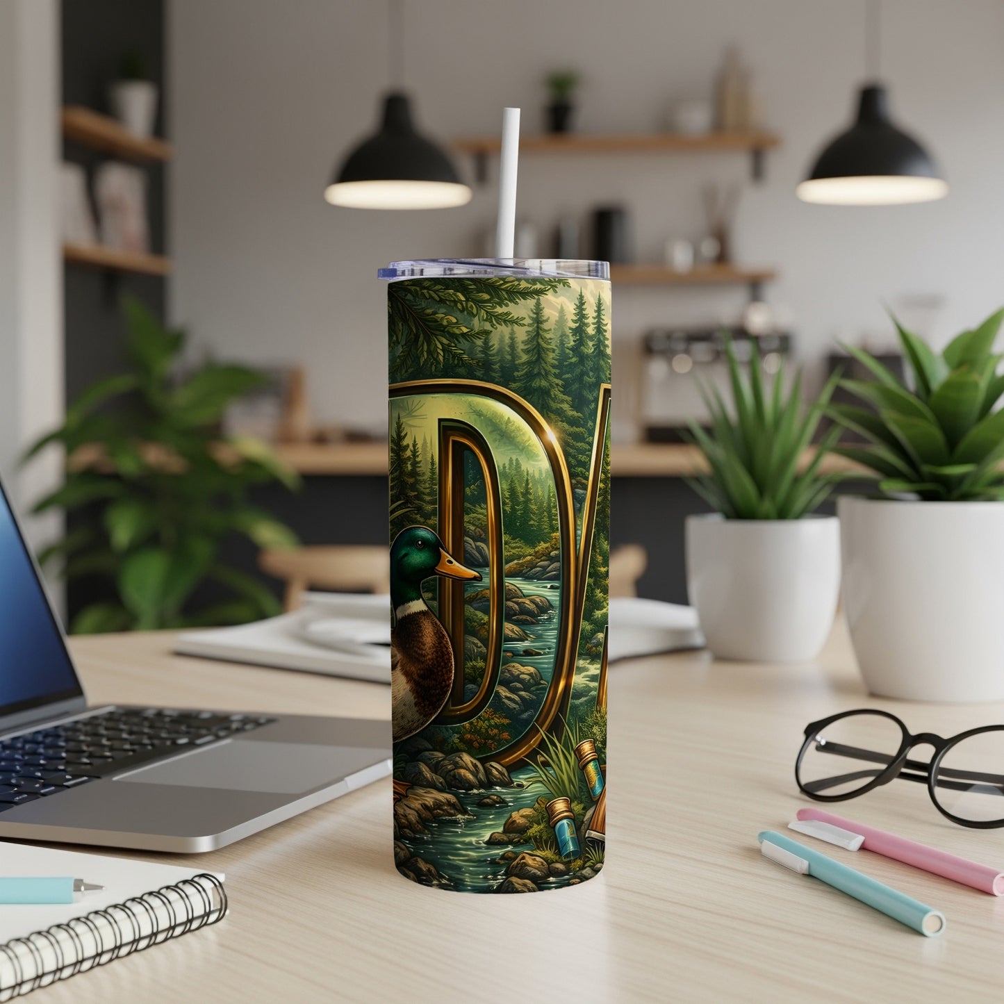Tall tumbler with a forest and river scene featuring a duck and golden "DJ" initials.