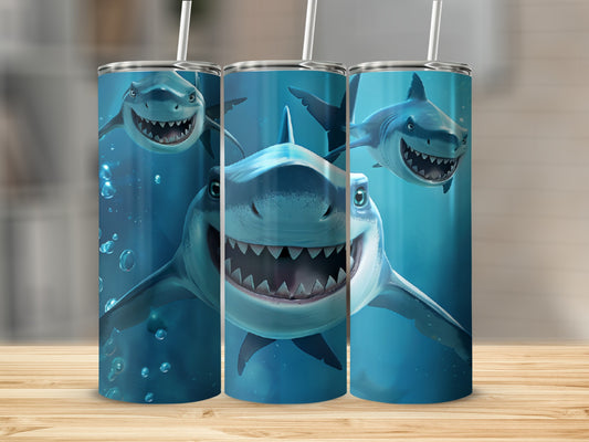 Three tumblers with cartoon sharks on a wooden surface.