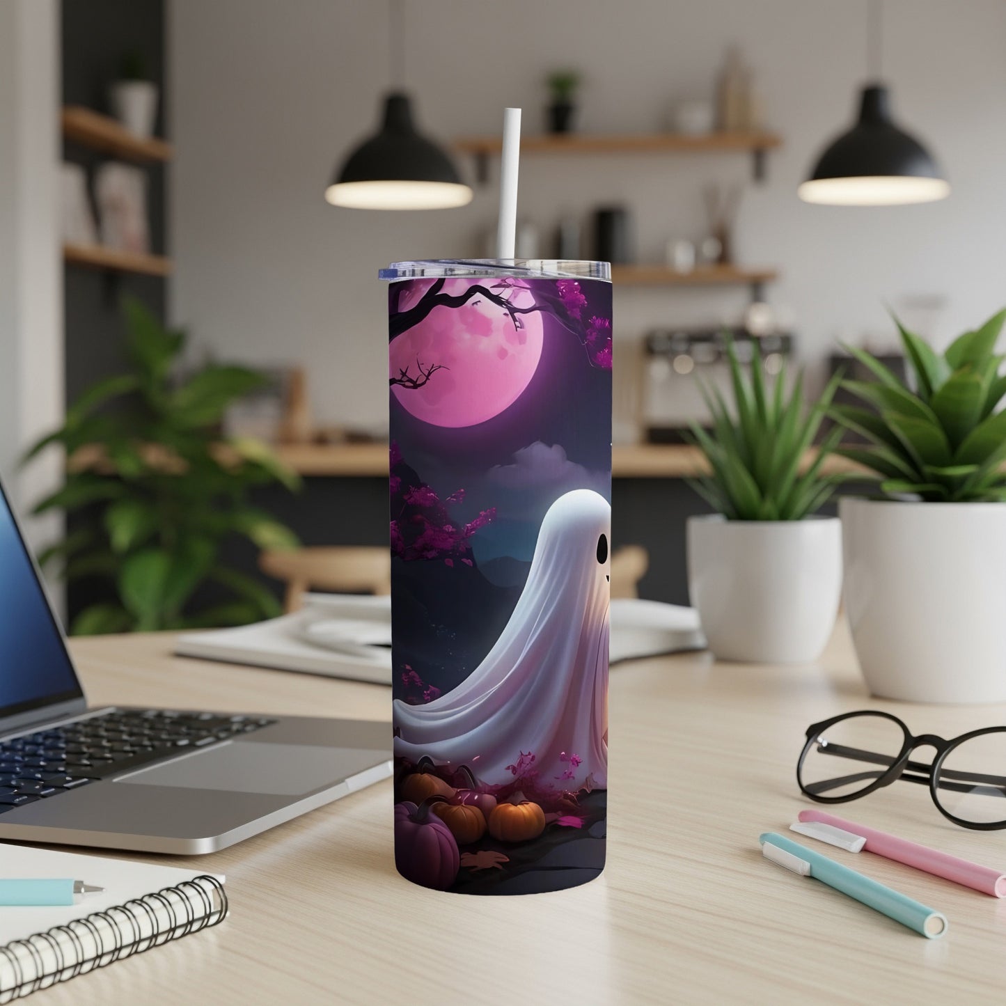 Tumbler with a white ghost and pumpkins under a pink moon and purple trees.